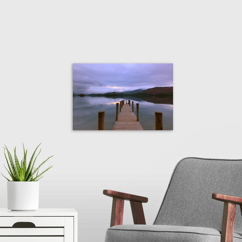 A modern room featuring Jetty at twilight in the Lake District looking across still water with reflections