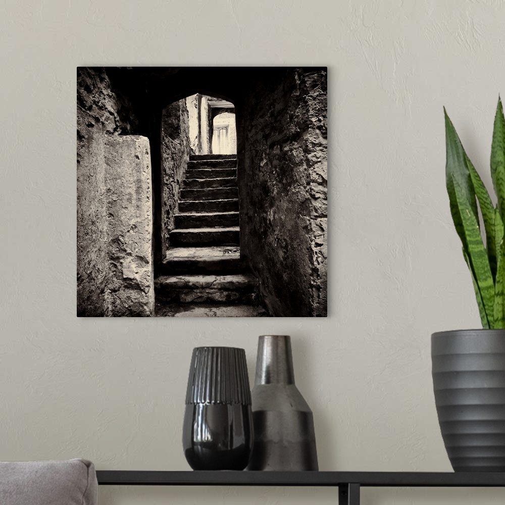 A modern room featuring Doorway and steps in medieval castle ruins. Beupre Castle, Wales