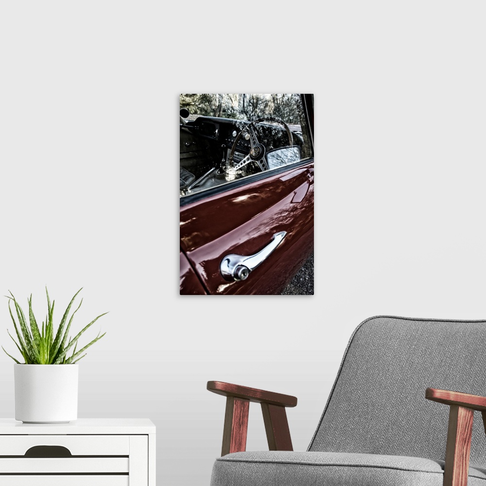 A modern room featuring Classic red 1960's e-type jaguar car with 4.2 litre engine
