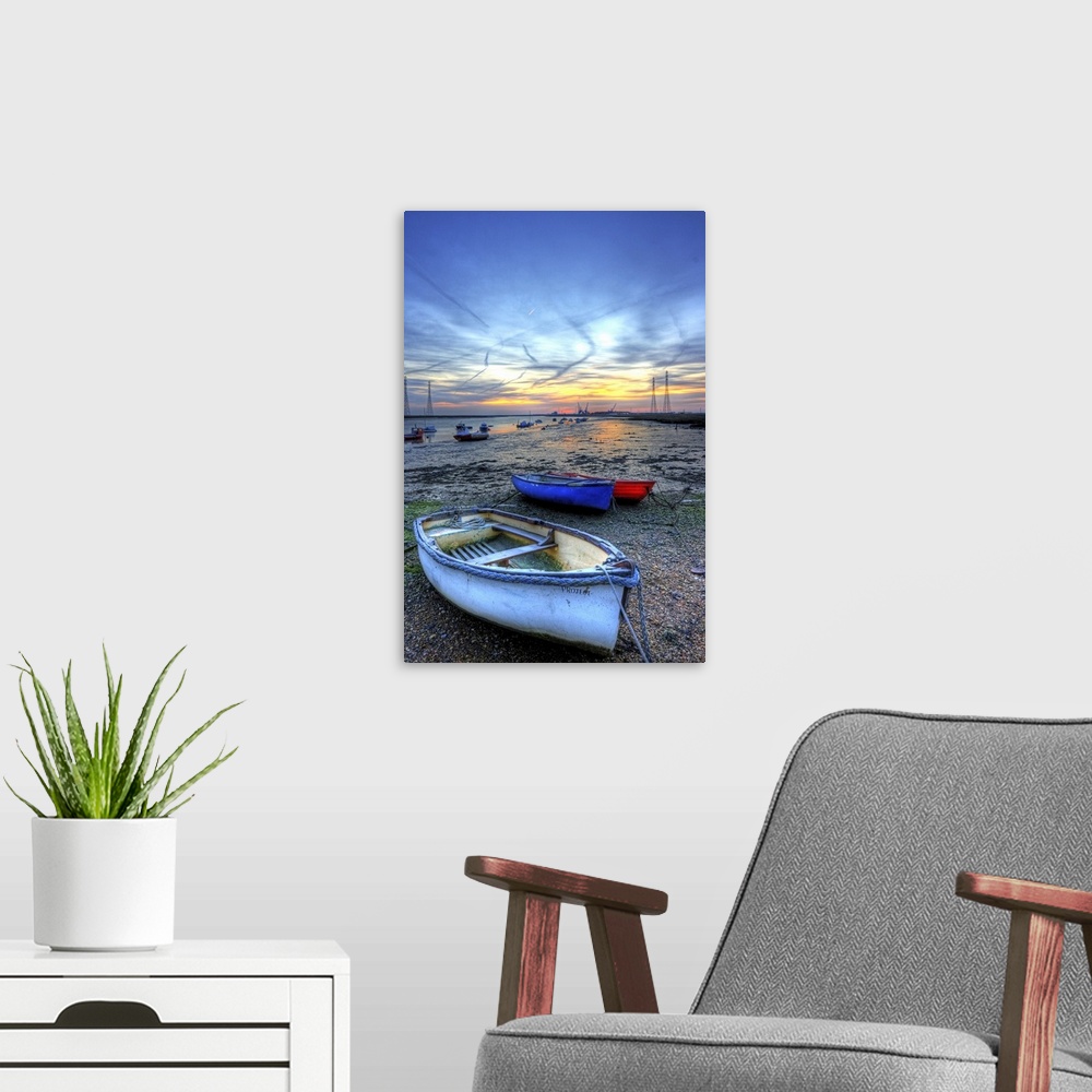 A modern room featuring Early morning frosty mid winter sunrise over the river swale and low tide mud flats and boats and...