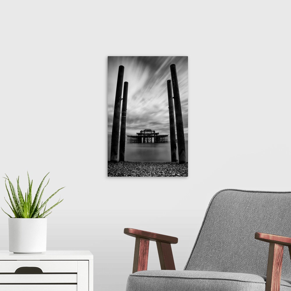 A modern room featuring Burnt out remains of the east pier in Brighton in East Sussex, England with long exposure