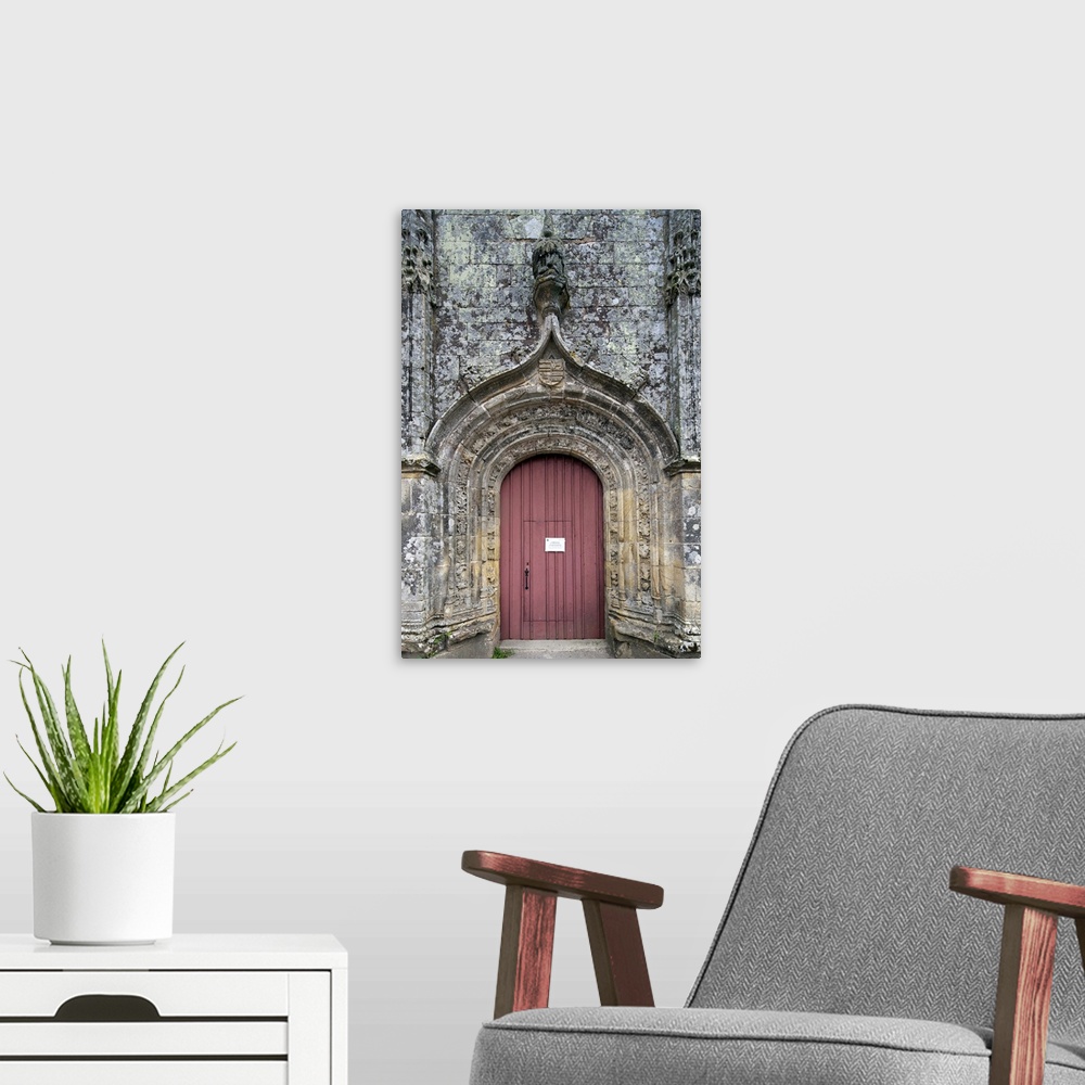 A modern room featuring Entrance door of the Trinity chapel, town of Plumergat, France
