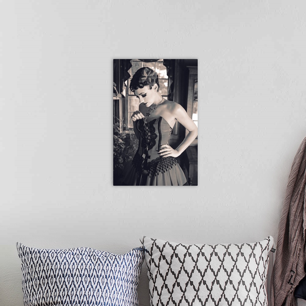 A bohemian room featuring A vintage photo of a saloon girl in a fancy dress in front of a window looking down and holding h...