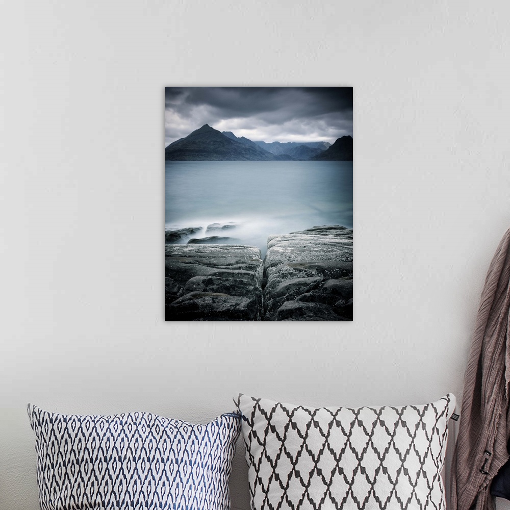 A bohemian room featuring Looking across the sea to the Isle of Skye with mountains under a grey sky