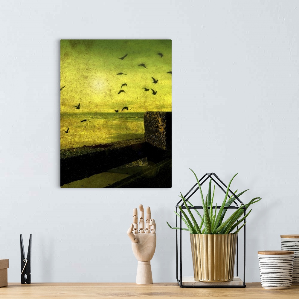 A bohemian room featuring A flock of birds flying over a beach scene with breakers