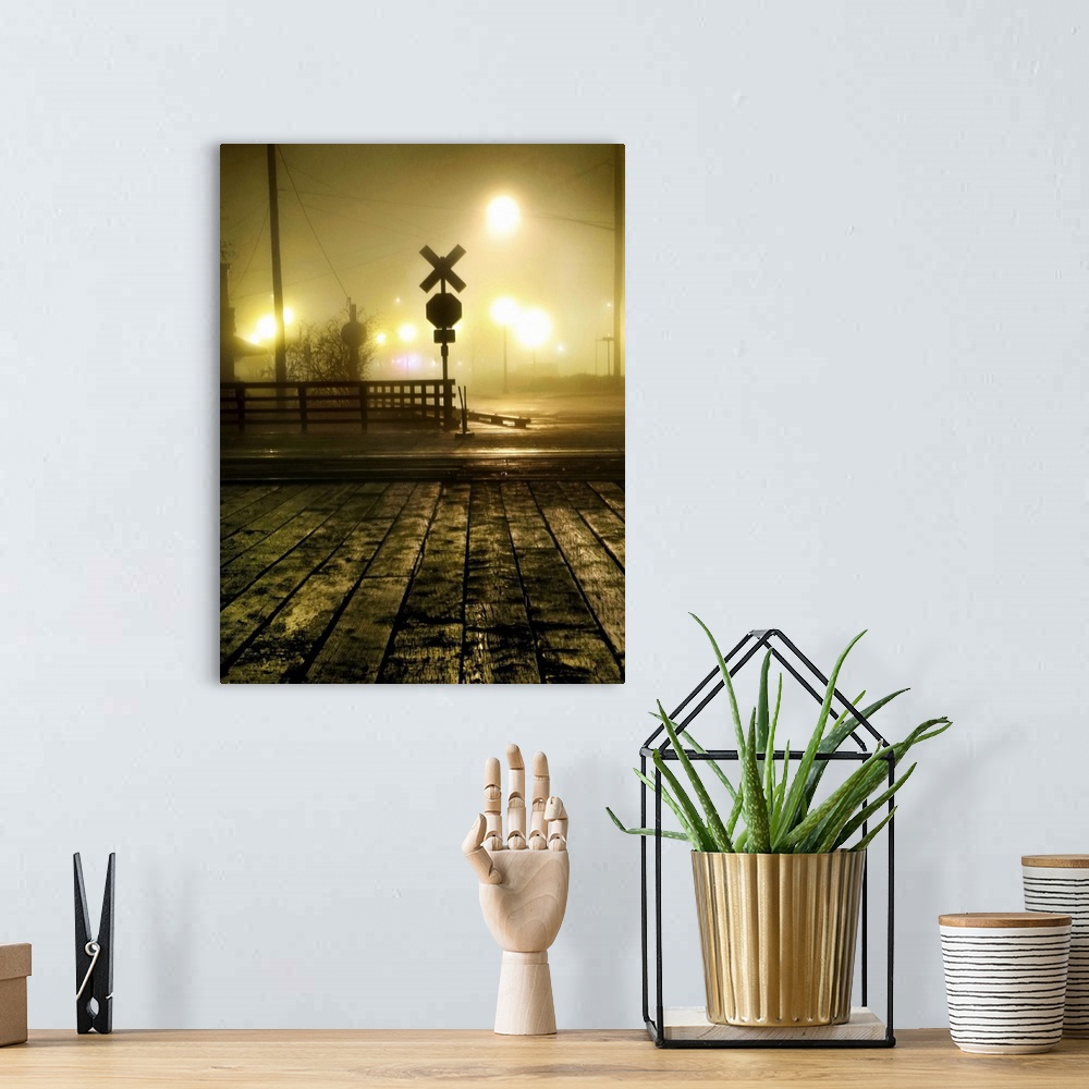 A bohemian room featuring Fog at a rail crossing with street lights in the distance