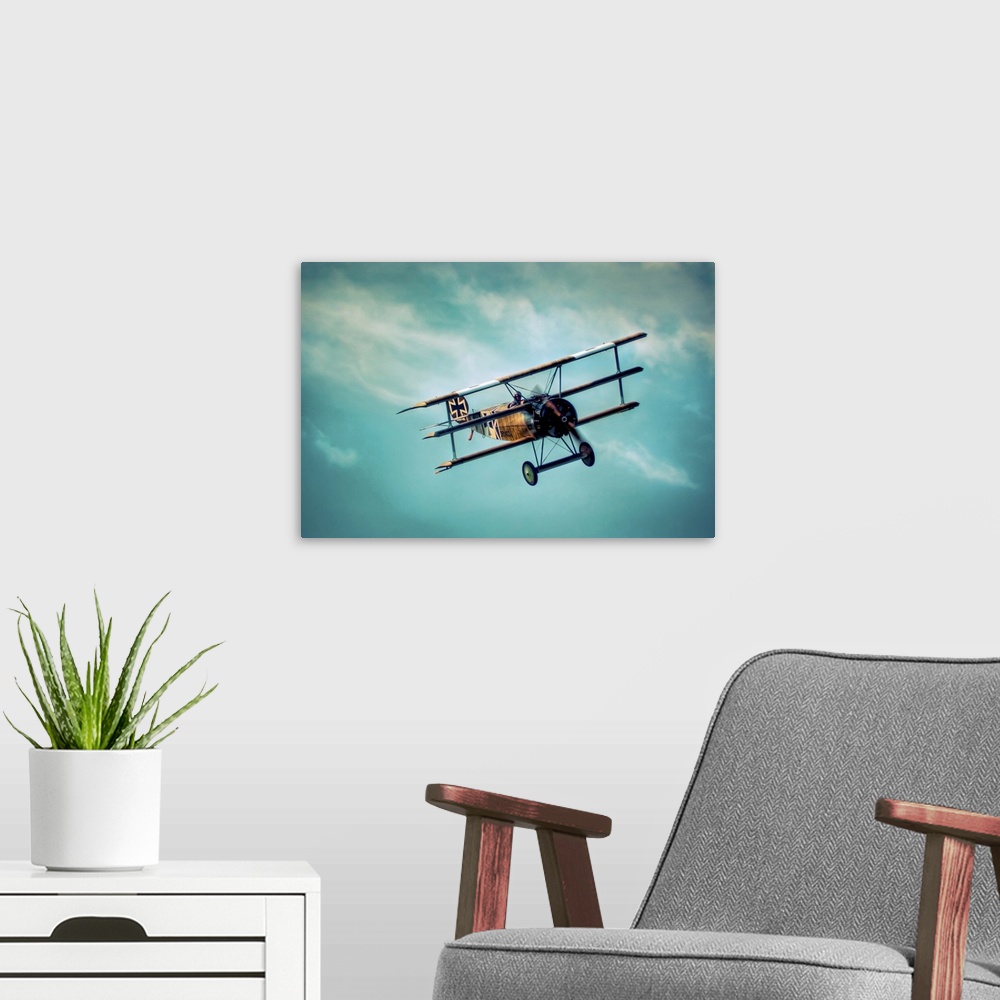 A modern room featuring A Fokker Dr1 in flight at high altitude