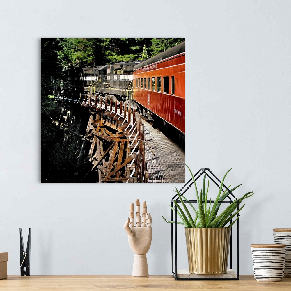 A bohemian room featuring A train crossing a wooden bridge