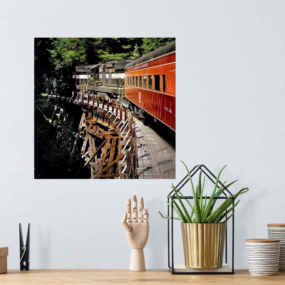 A bohemian room featuring A train crossing a wooden bridge