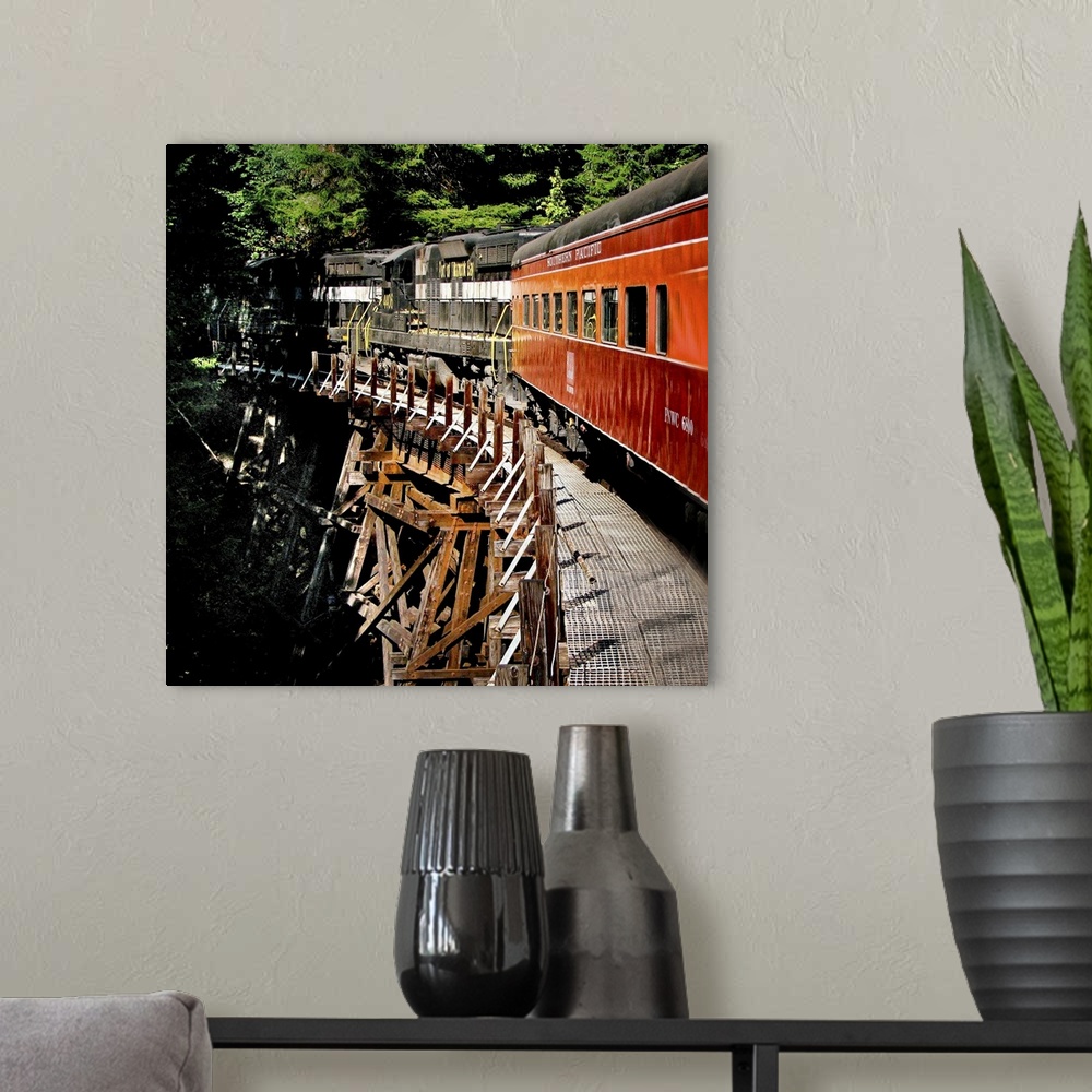 A modern room featuring A train crossing a wooden bridge