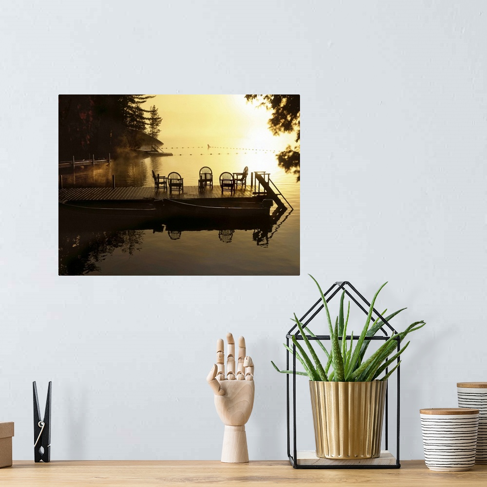 A bohemian room featuring Sunsetting over a golden lake with a timber jetty with chairs