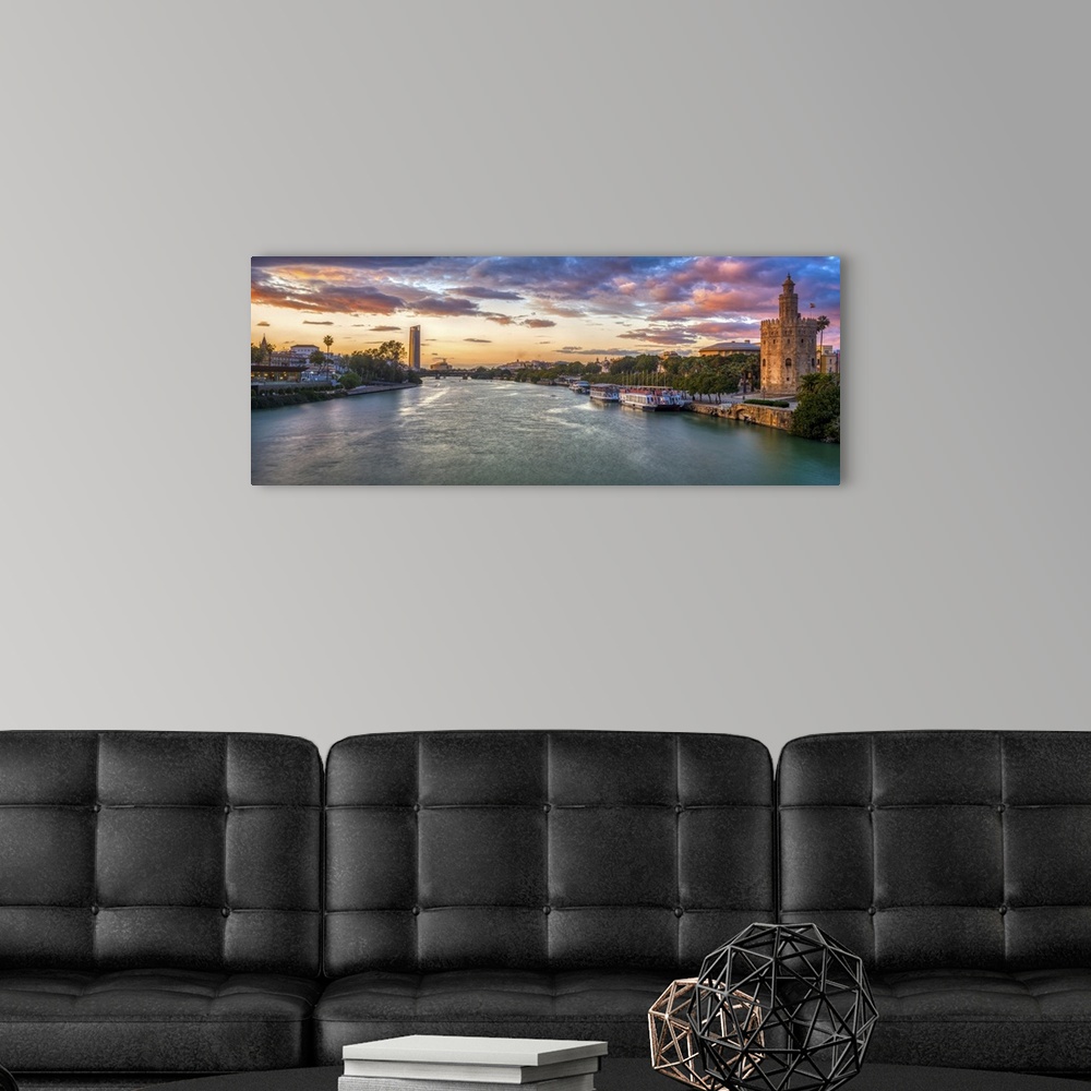 A modern room featuring Panoramic view of the Guadalquivir River at dusk from San Telmo Bridge, Seville, Spain.
