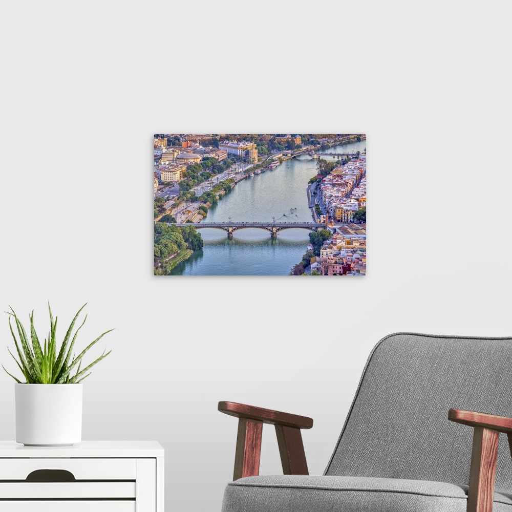 A modern room featuring Aerial view of Triana (foreground) and San Telmo (background) bridges over the Guadalquivir river...