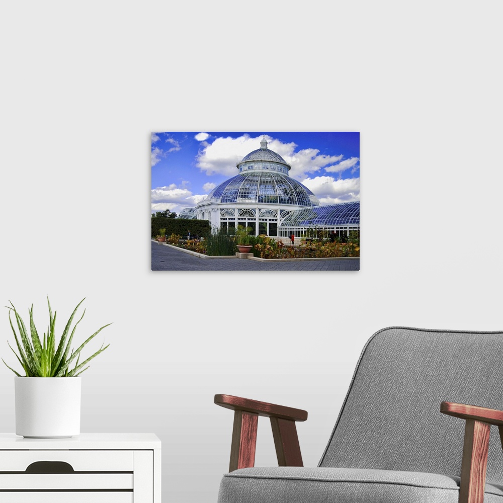 A modern room featuring The Palm House or Haupt Conservatory in the New York Botanical Gardens.