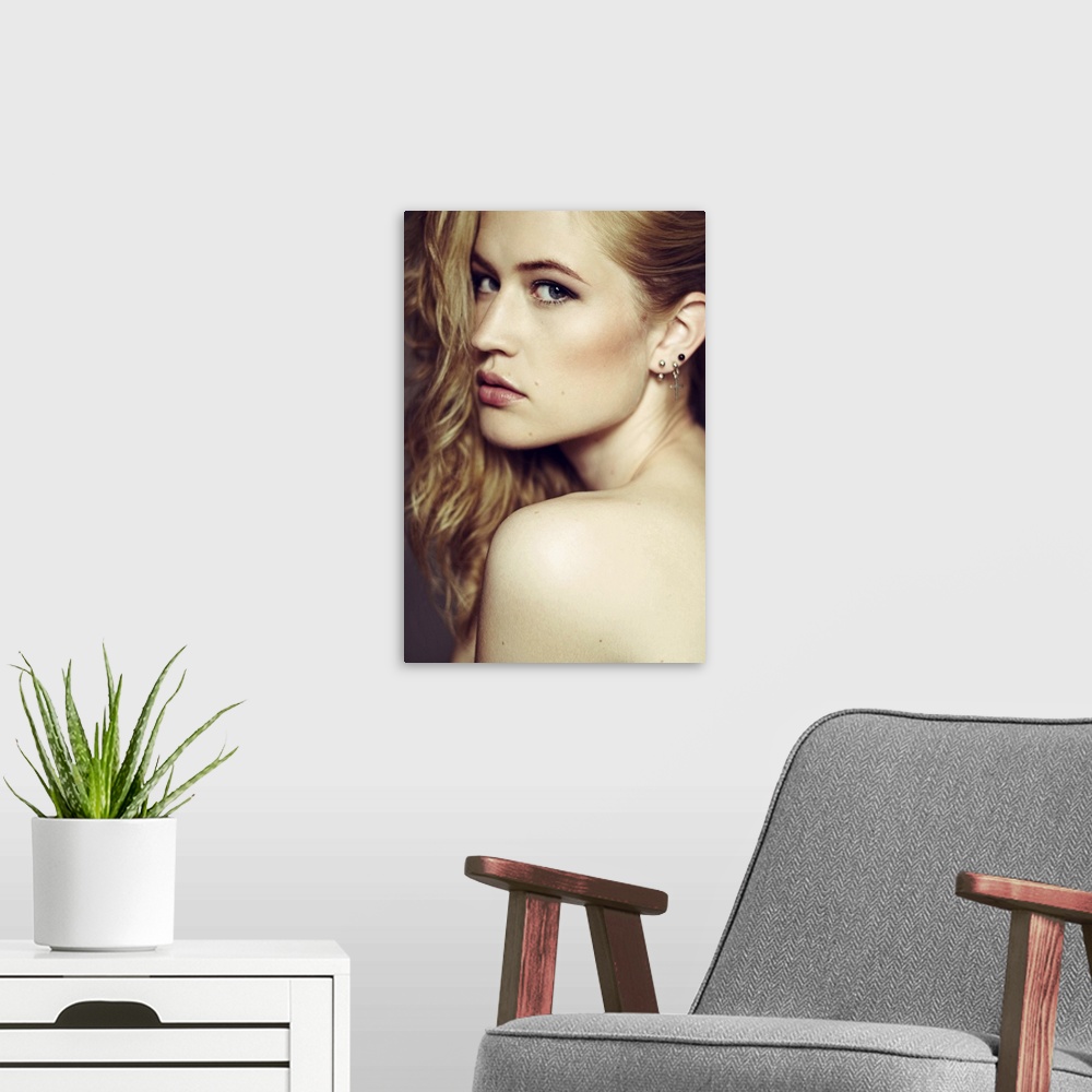 A modern room featuring Dramatic portrait of young woman looking over her shoulder