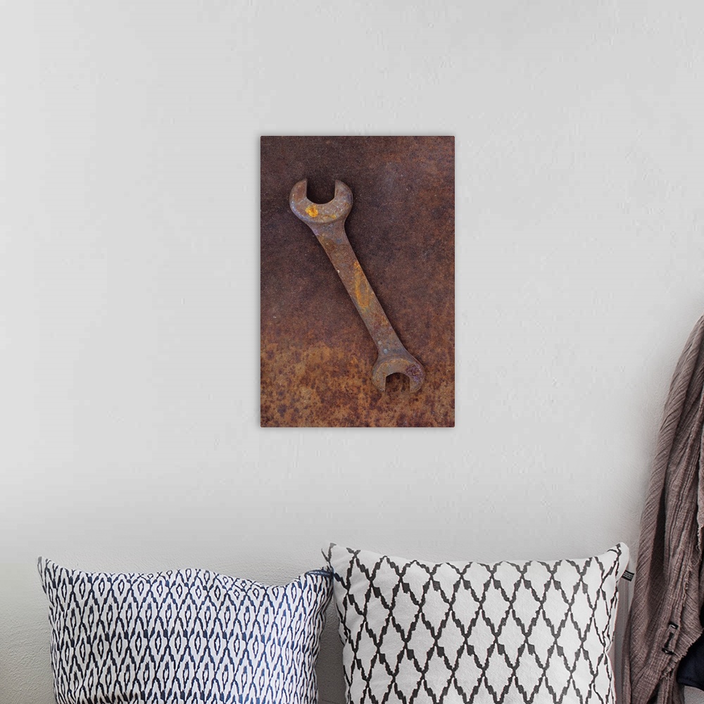 A bohemian room featuring Heavy double-headed spanner lying on rusty metal sheet