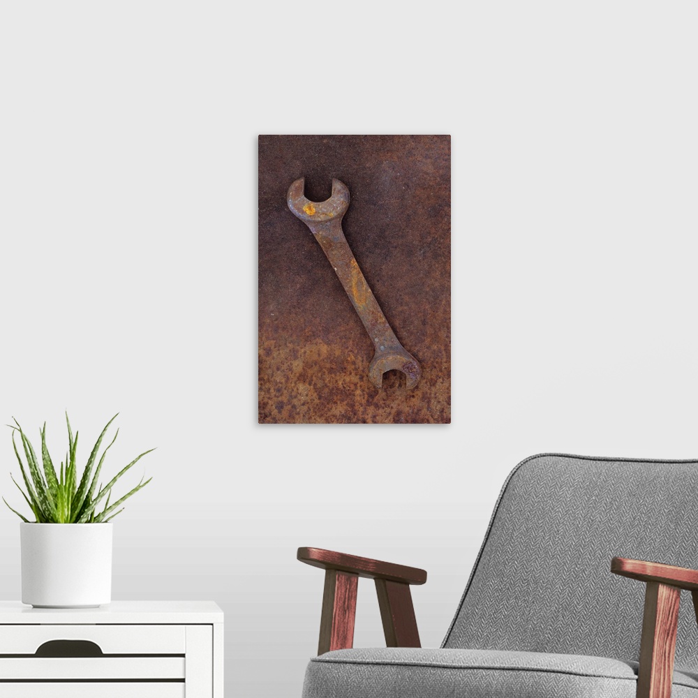 A modern room featuring Heavy double-headed spanner lying on rusty metal sheet