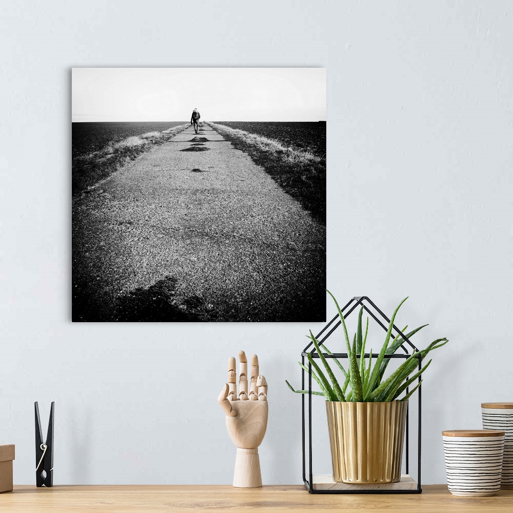 A bohemian room featuring Lone figure on road, hiking with backpack