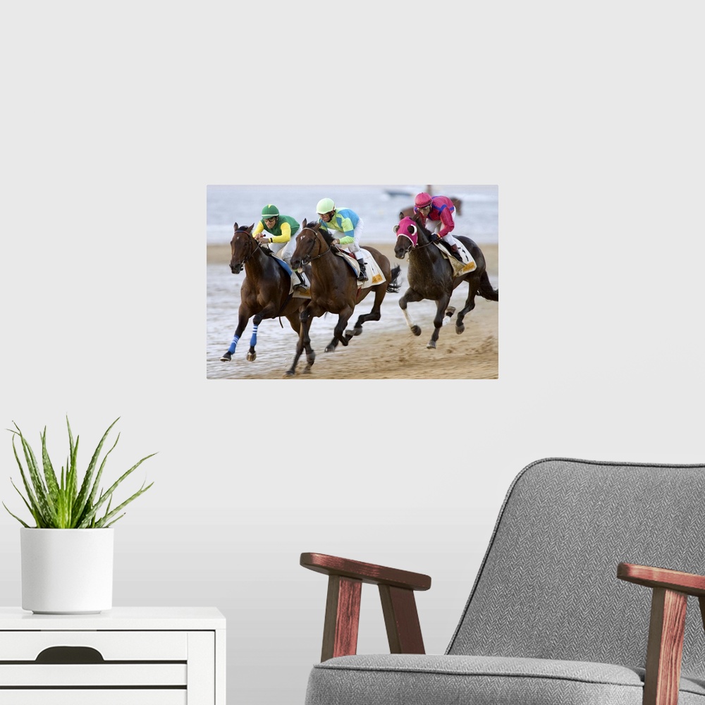 A modern room featuring Thoroughbred horses compete at sea shore with green horizon of ?Doana National Park? and the whol...