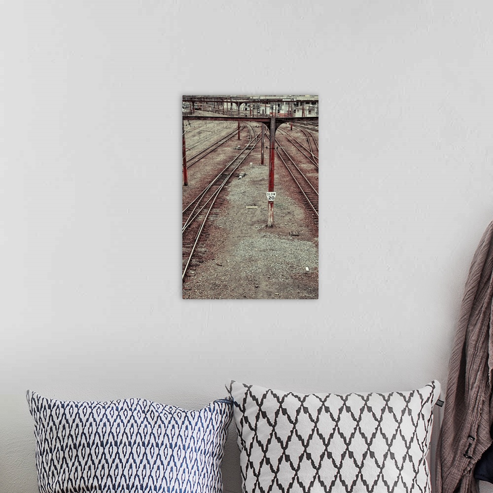 A bohemian room featuring train tracks leading into a city station