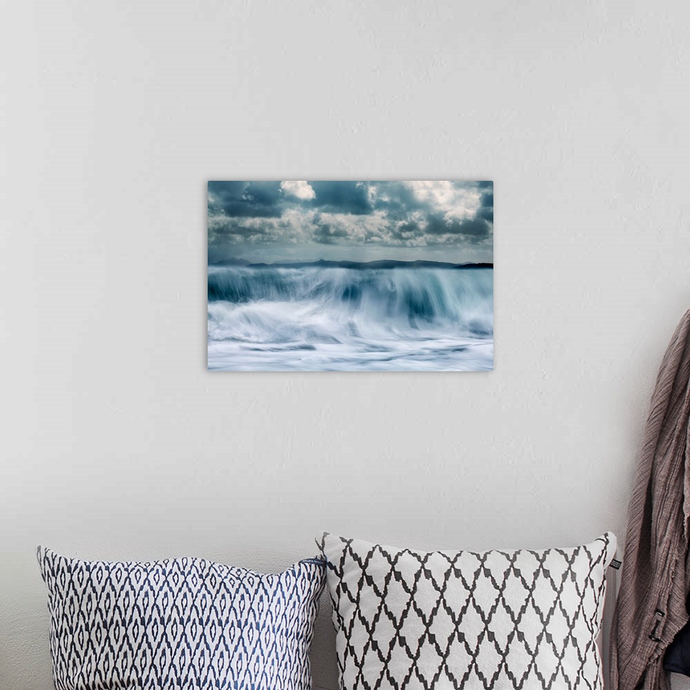 A bohemian room featuring Crashing waves with a mountain background