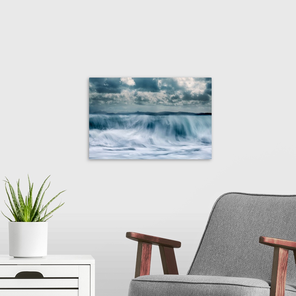 A modern room featuring Crashing waves with a mountain background