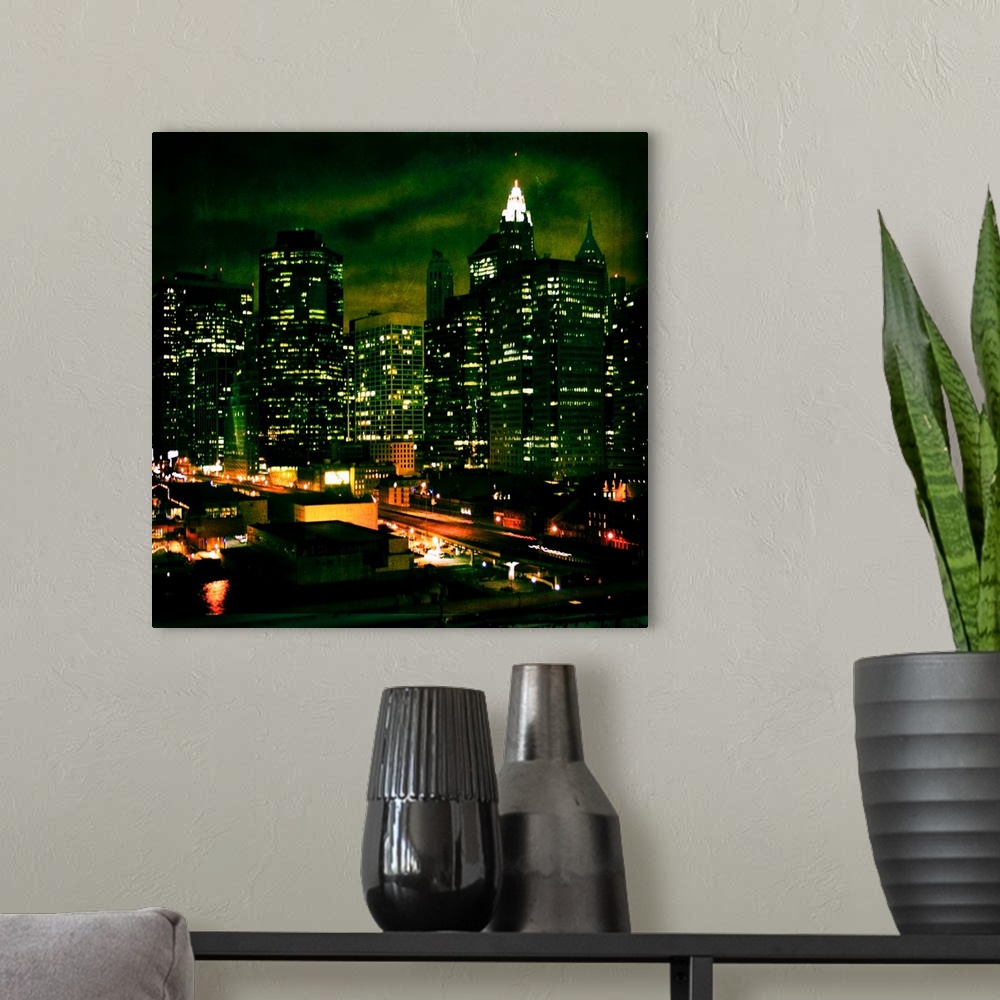 A modern room featuring New York City at night with highrise buildings