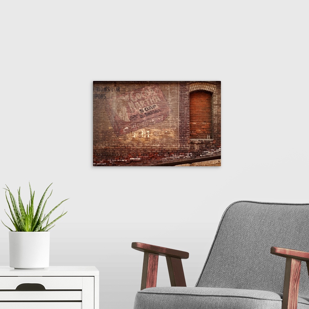 A modern room featuring Old brick Naptha sign on a downtown Los Angeles building