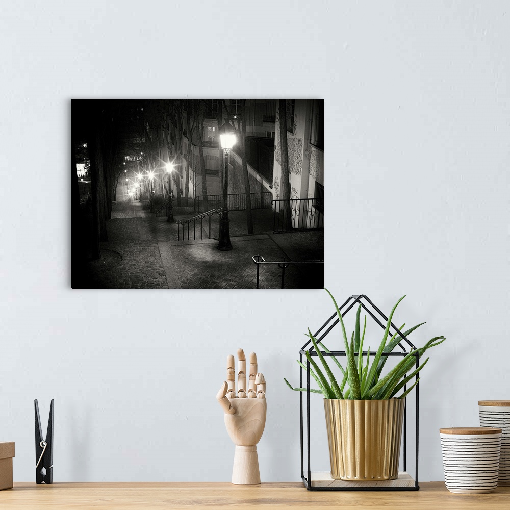 A bohemian room featuring Steps on Parisian street at night with glowing street lamps