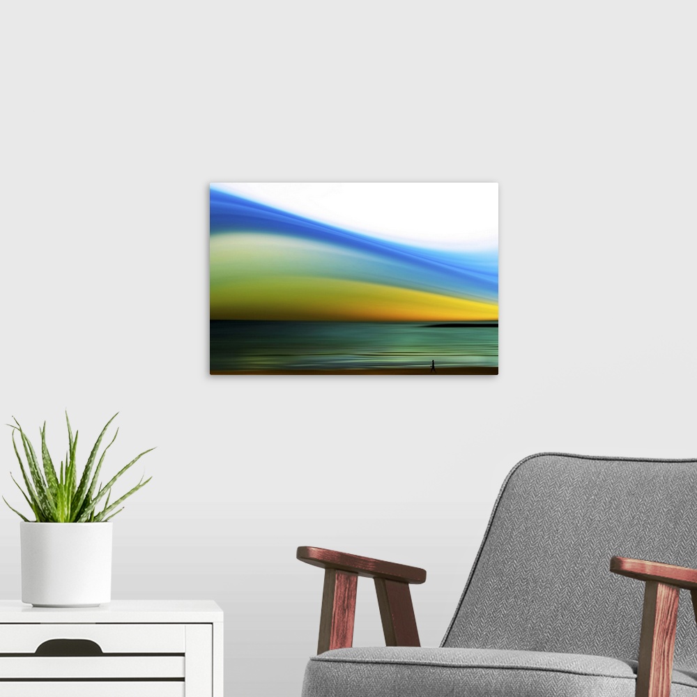 A modern room featuring Wall art of a person's silhouette walking on the shore of a beach with an abstractly colored sky.