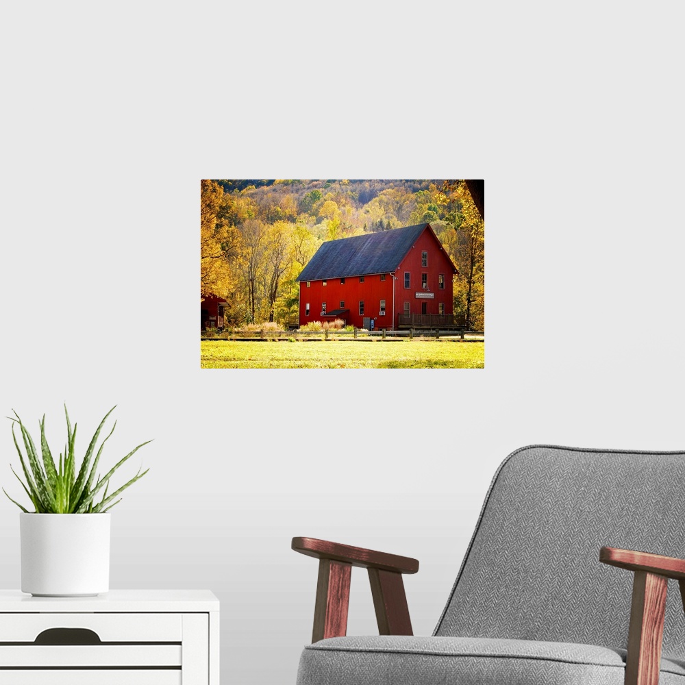 A modern room featuring Typical red barn surrounded by vibrant autumn foliage. Kent, Connecticut.
