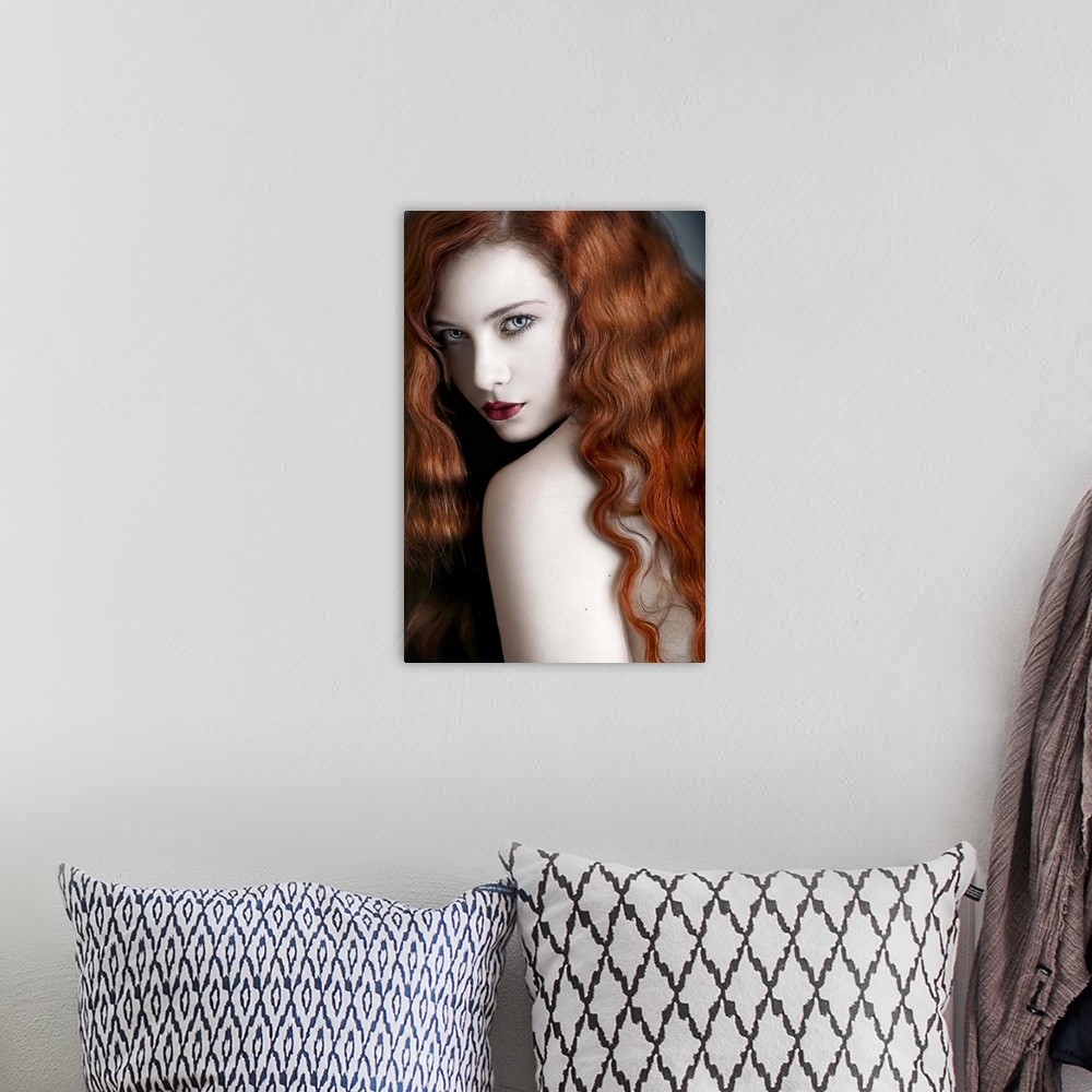 A bohemian room featuring A glamorous portrait of a young adult with wavy red hair looking over her shoulder