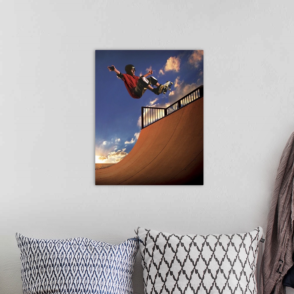 A bohemian room featuring A young boy gets air on his skateboard while skating on a mini ramp at sunset