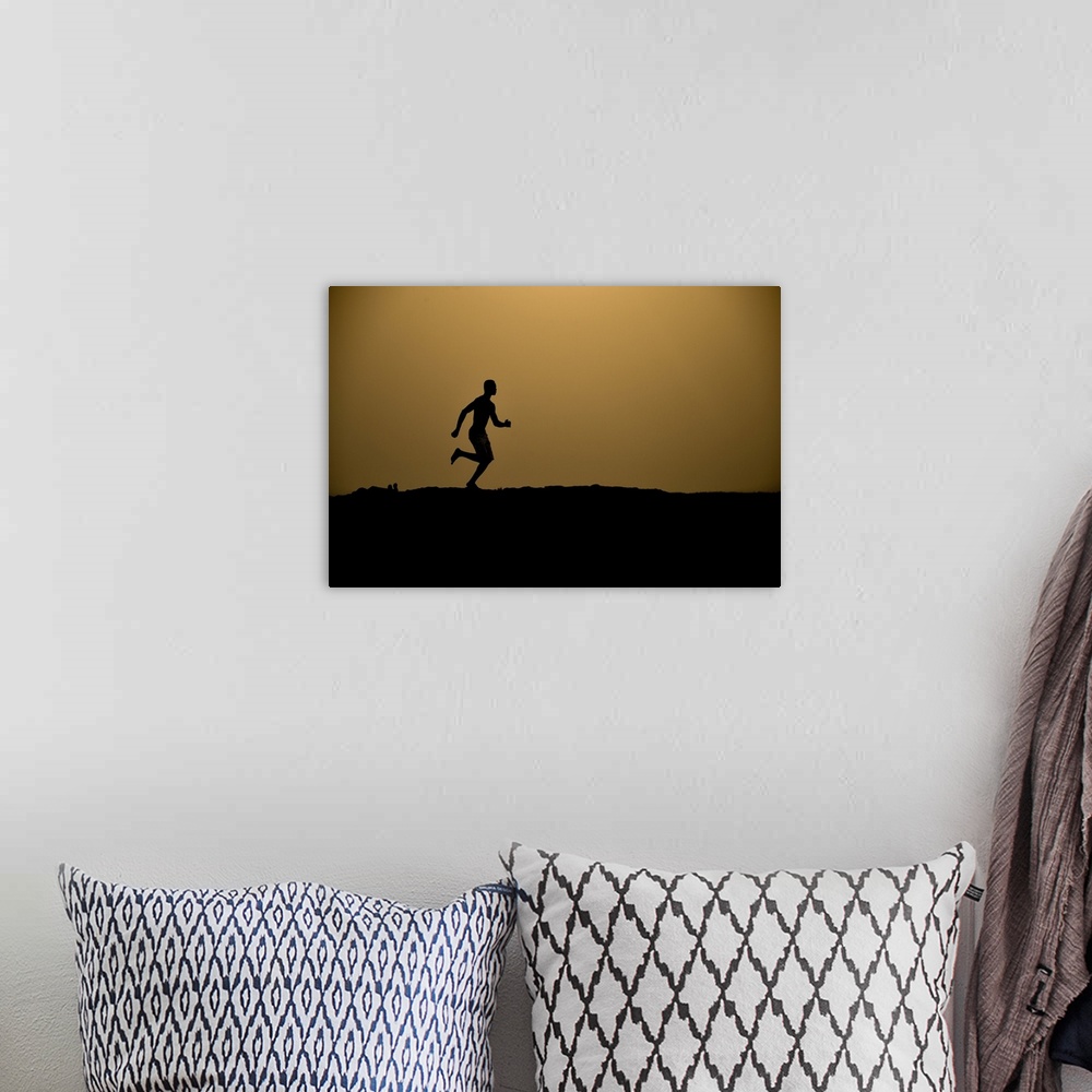 A bohemian room featuring Barefoot man running.