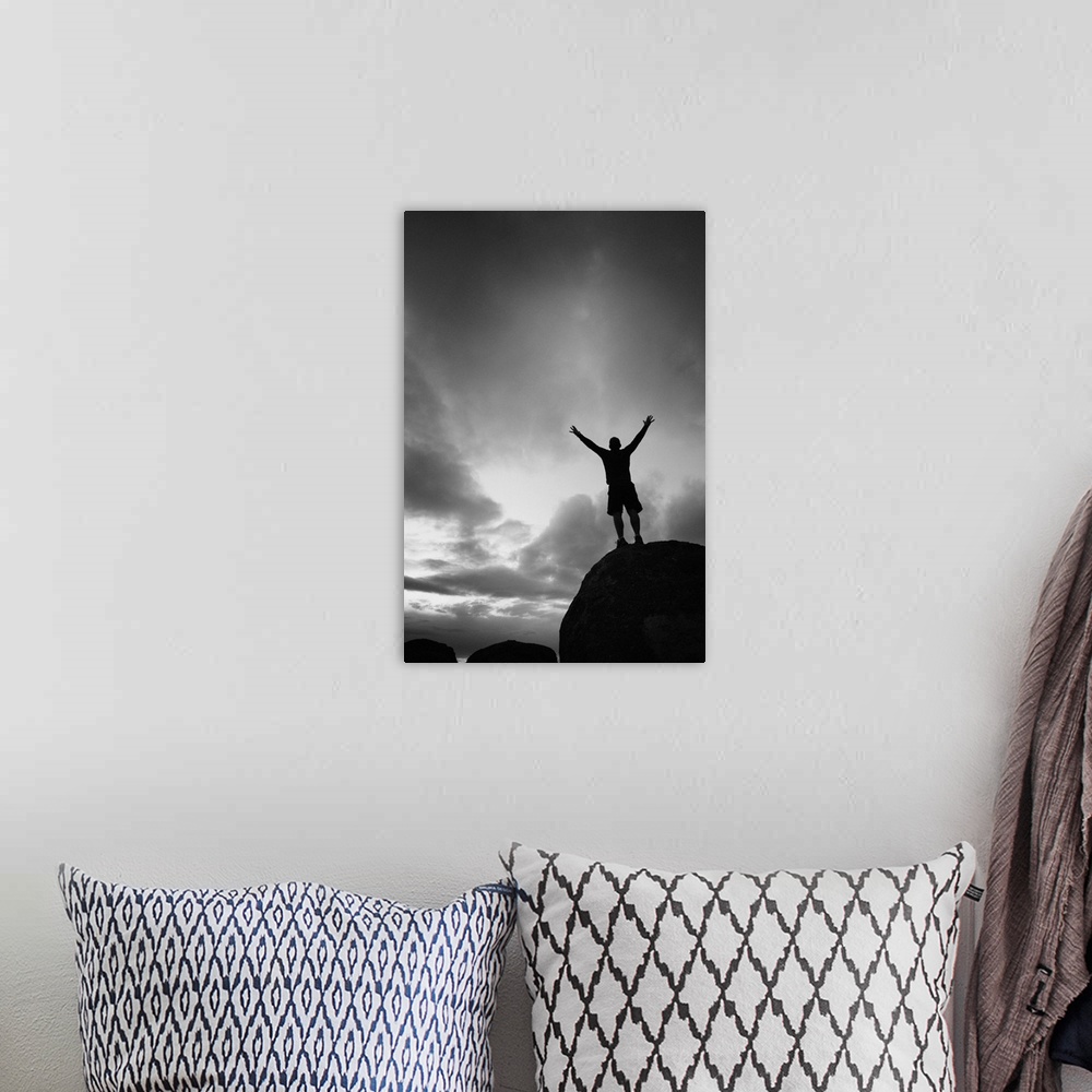 A bohemian room featuring Silhouette man arms raised into the New Mexico sky in black and