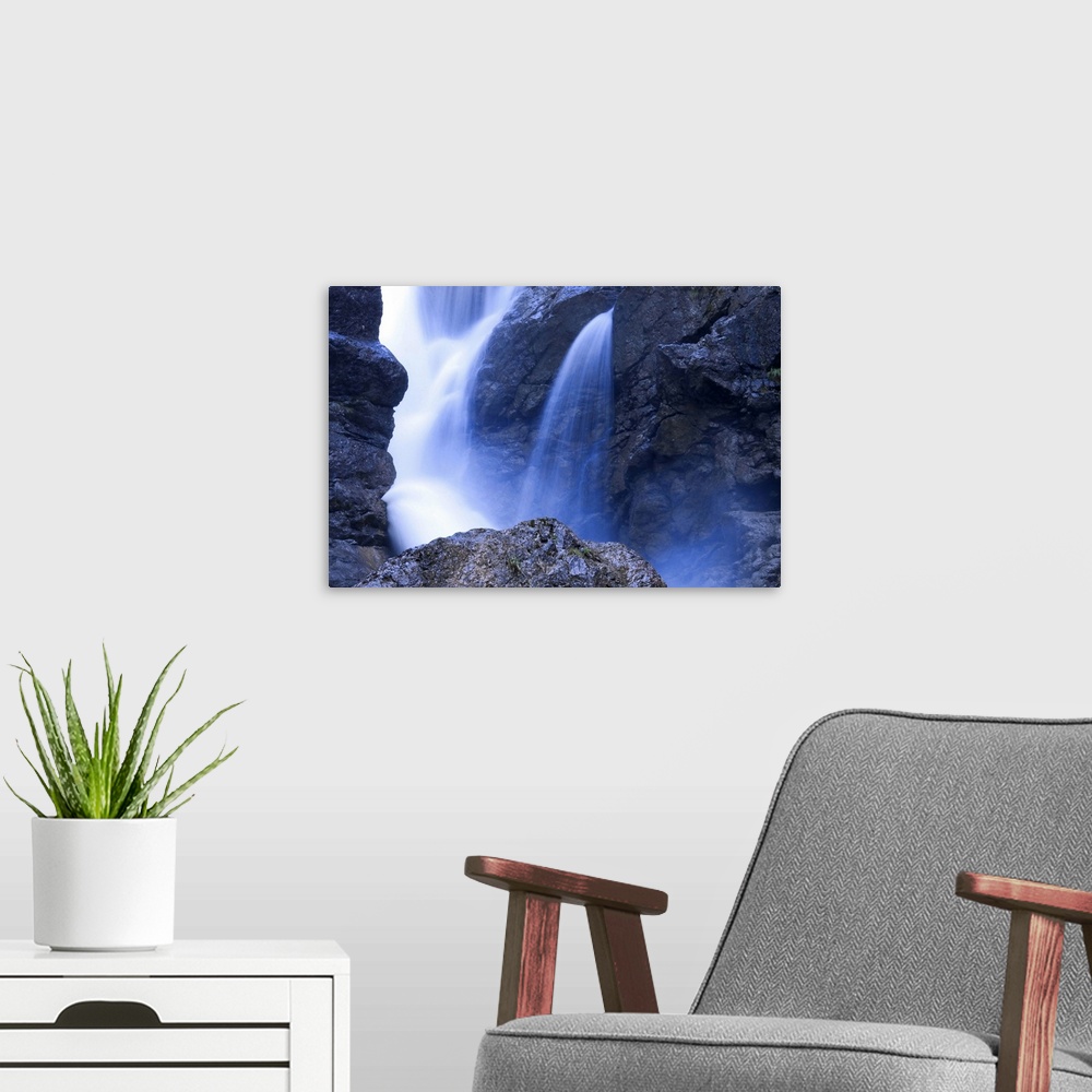 A modern room featuring Close up of part of a waterfall, slow shutter speed creating silky water.