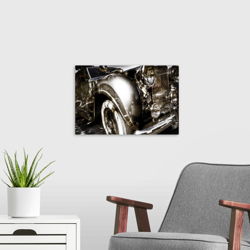 A modern room featuring A vintage Rolls Royce motorcar with gleaming chrome grill and bumper