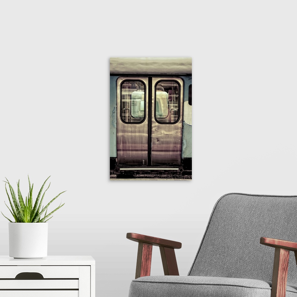 A modern room featuring doors to a train carraige