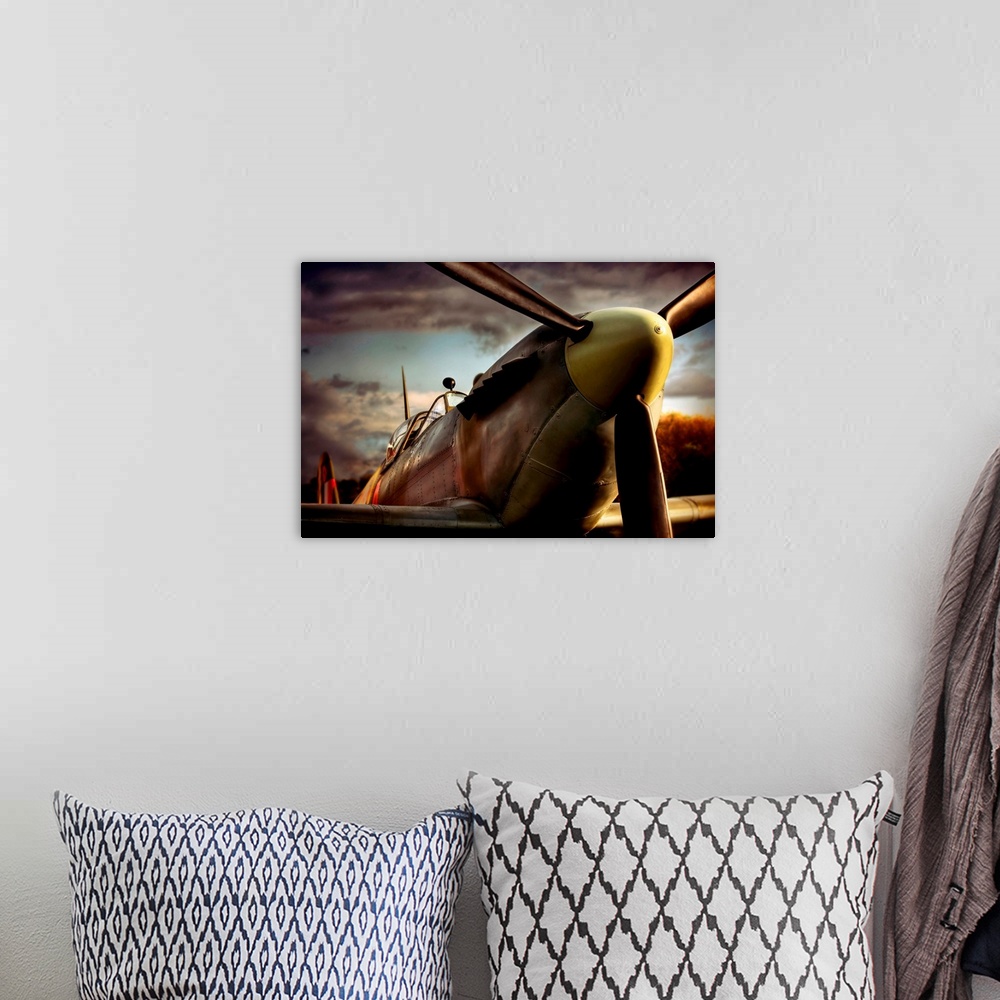 A bohemian room featuring Close up photograph of British Spitfire with dark cloudy sky in the background.  The plane is a s...