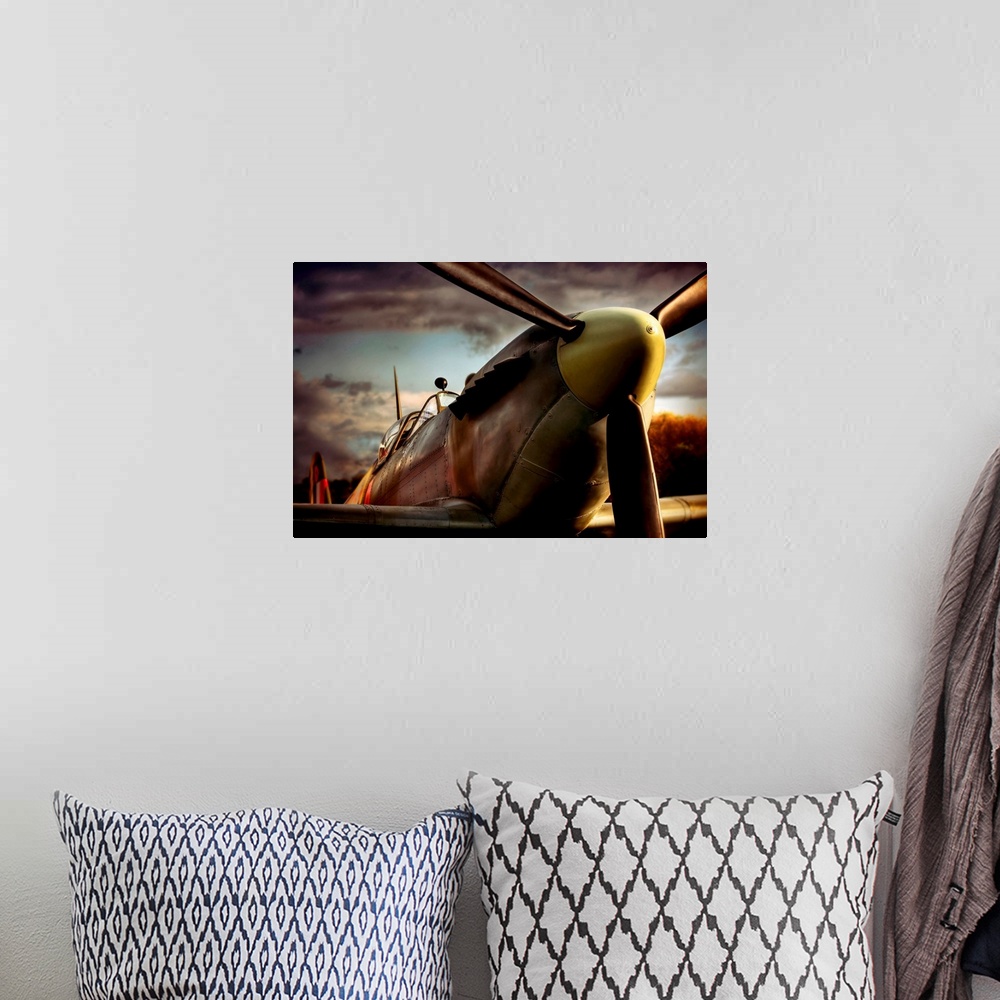 A bohemian room featuring Close up photograph of British Spitfire with dark cloudy sky in the background.  The plane is a s...