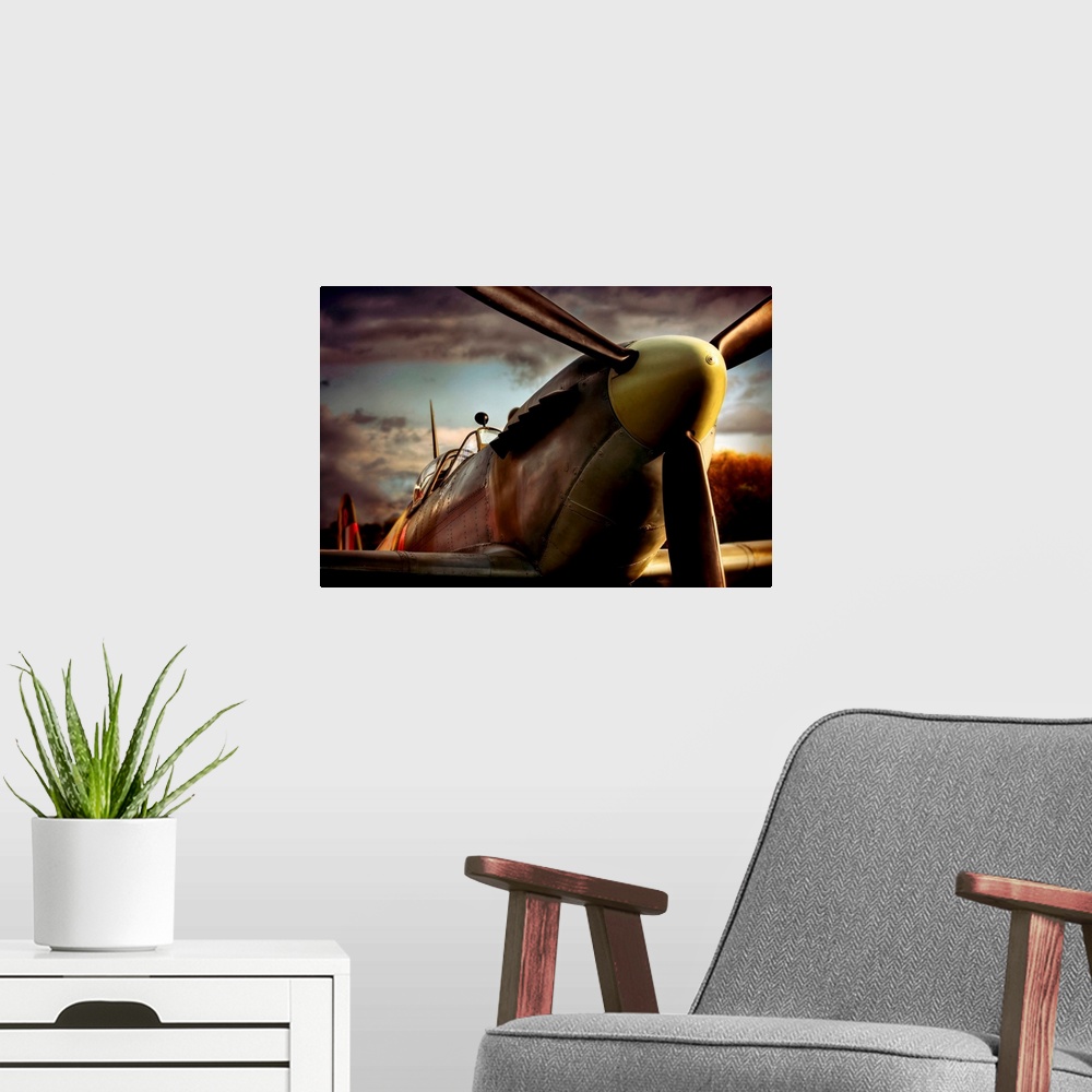 A modern room featuring Close up photograph of British Spitfire with dark cloudy sky in the background.  The plane is a s...