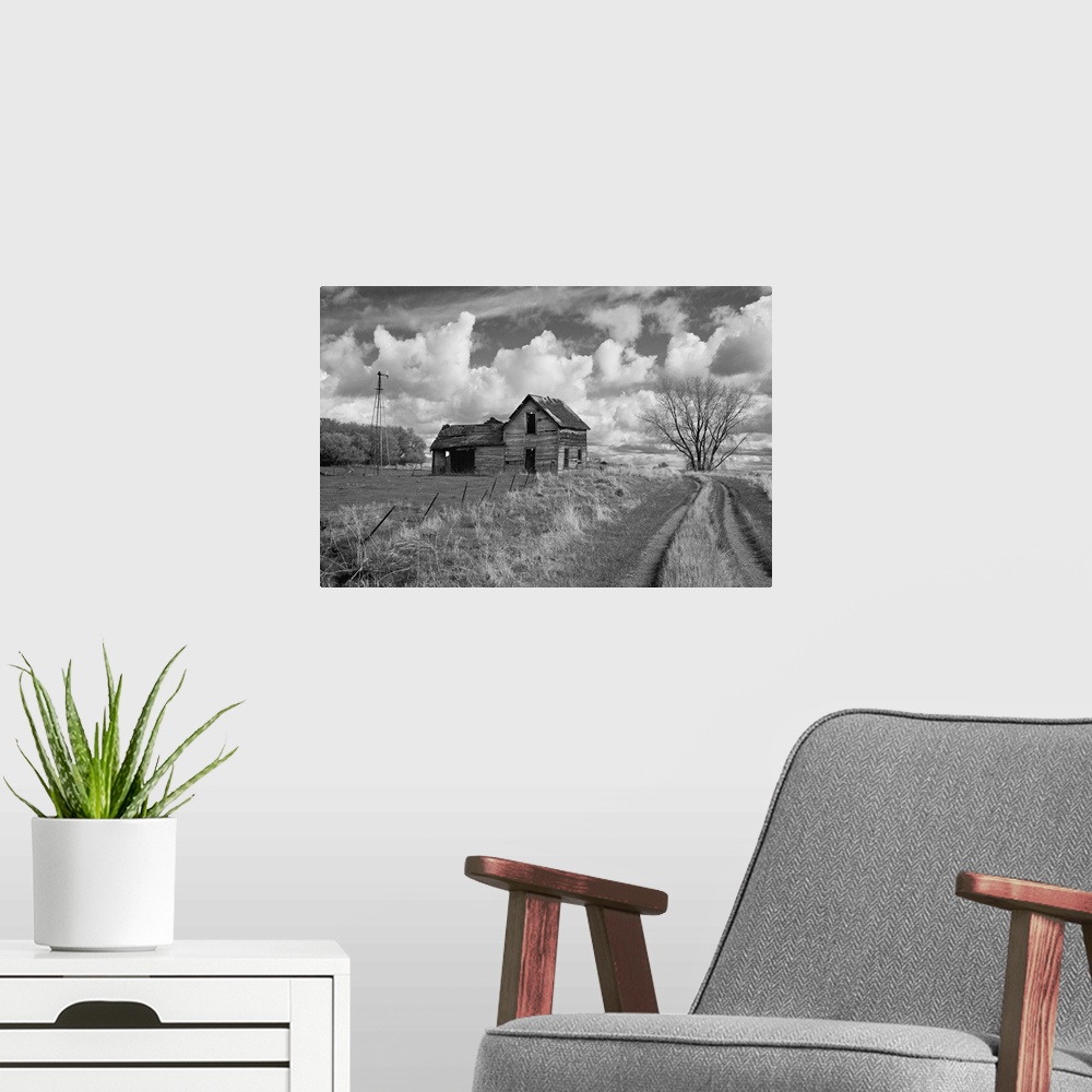 A modern room featuring rural scene with old barn and farm track under cloudy sky in Rolette County USA