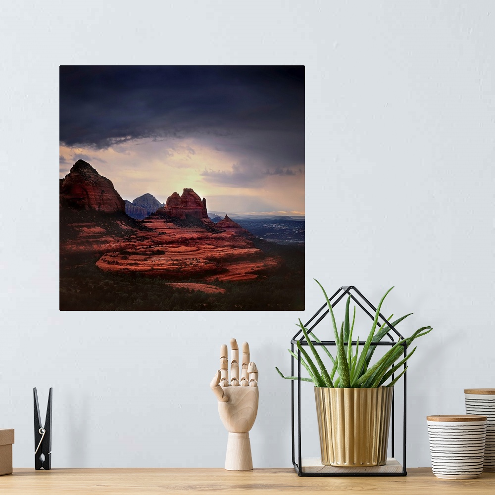 A bohemian room featuring Stormy skies ocer a mountainous landscape