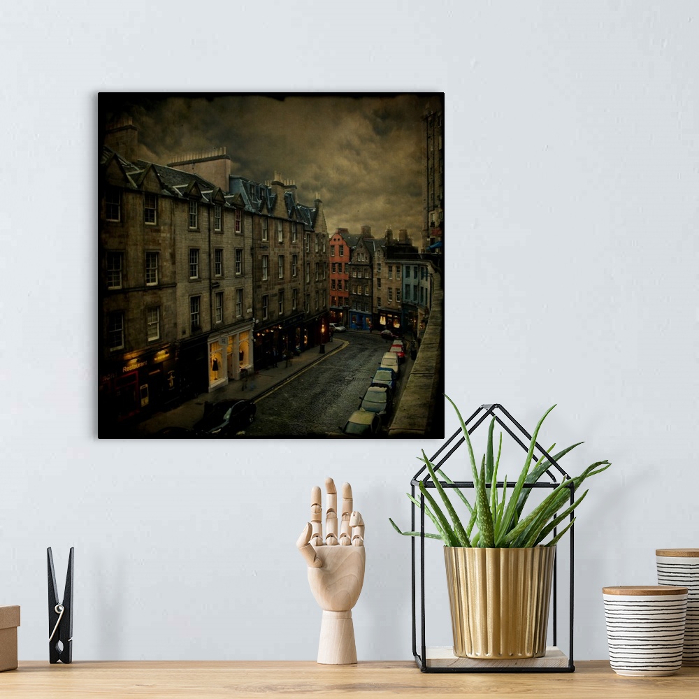A bohemian room featuring Stormy skies over a town street with cars and shops