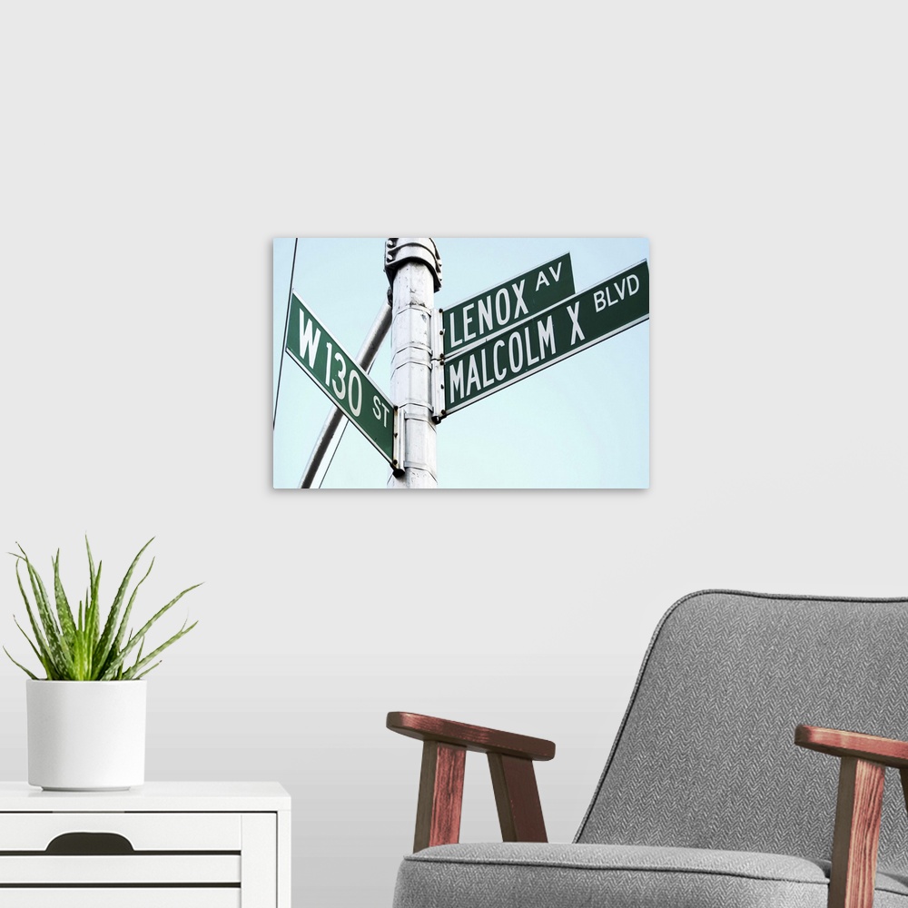A modern room featuring Street sign in Harlem, New York City, on Malcolm X Boulevard.