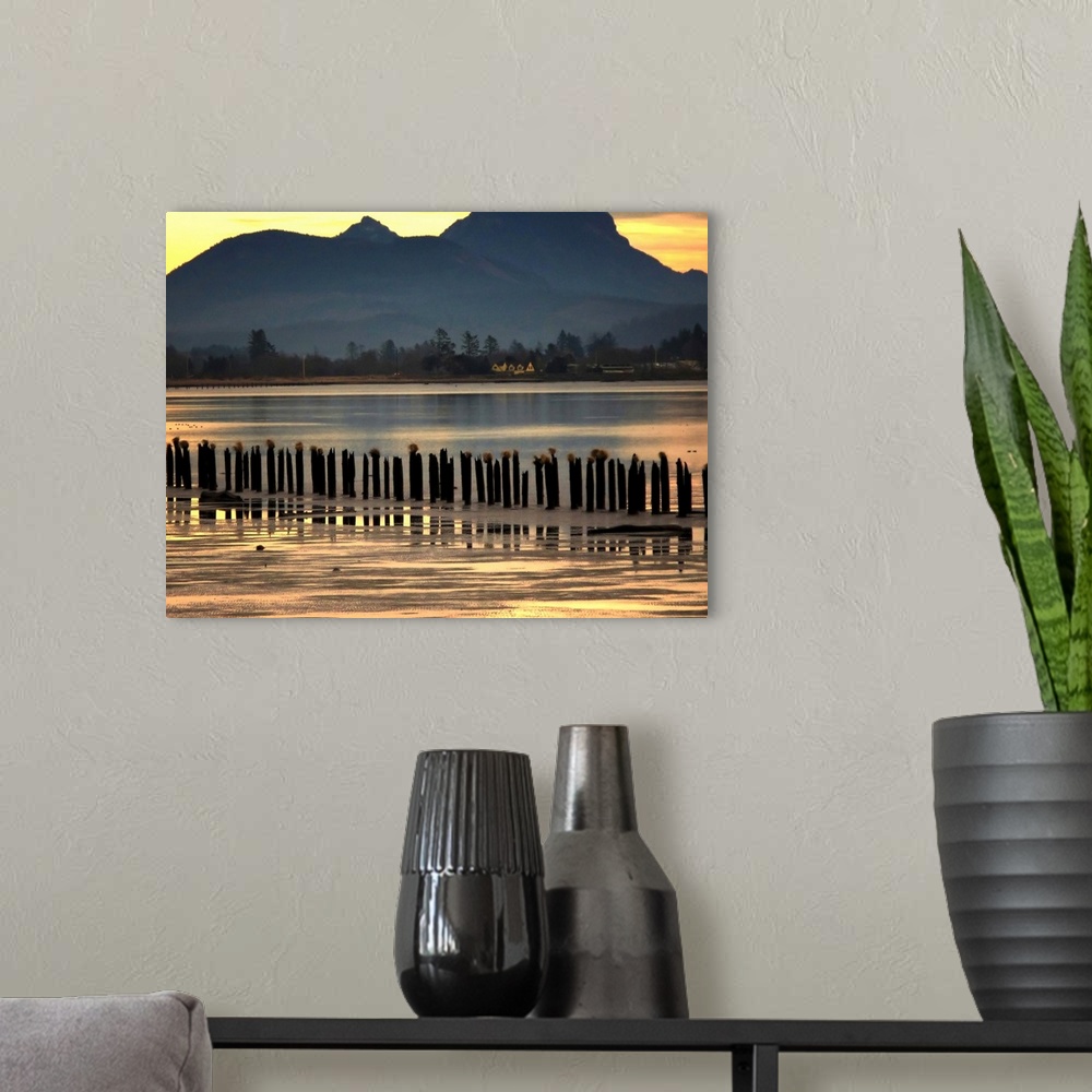 A modern room featuring View across a lake to mountains at sunset