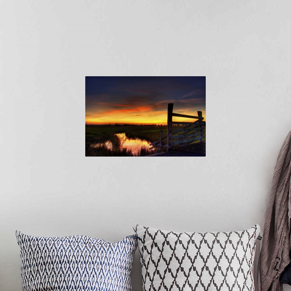 A bohemian room featuring Sunset over Elmley marshes, with the Swale Crossing and Kingsferry Bridge in the background and r...