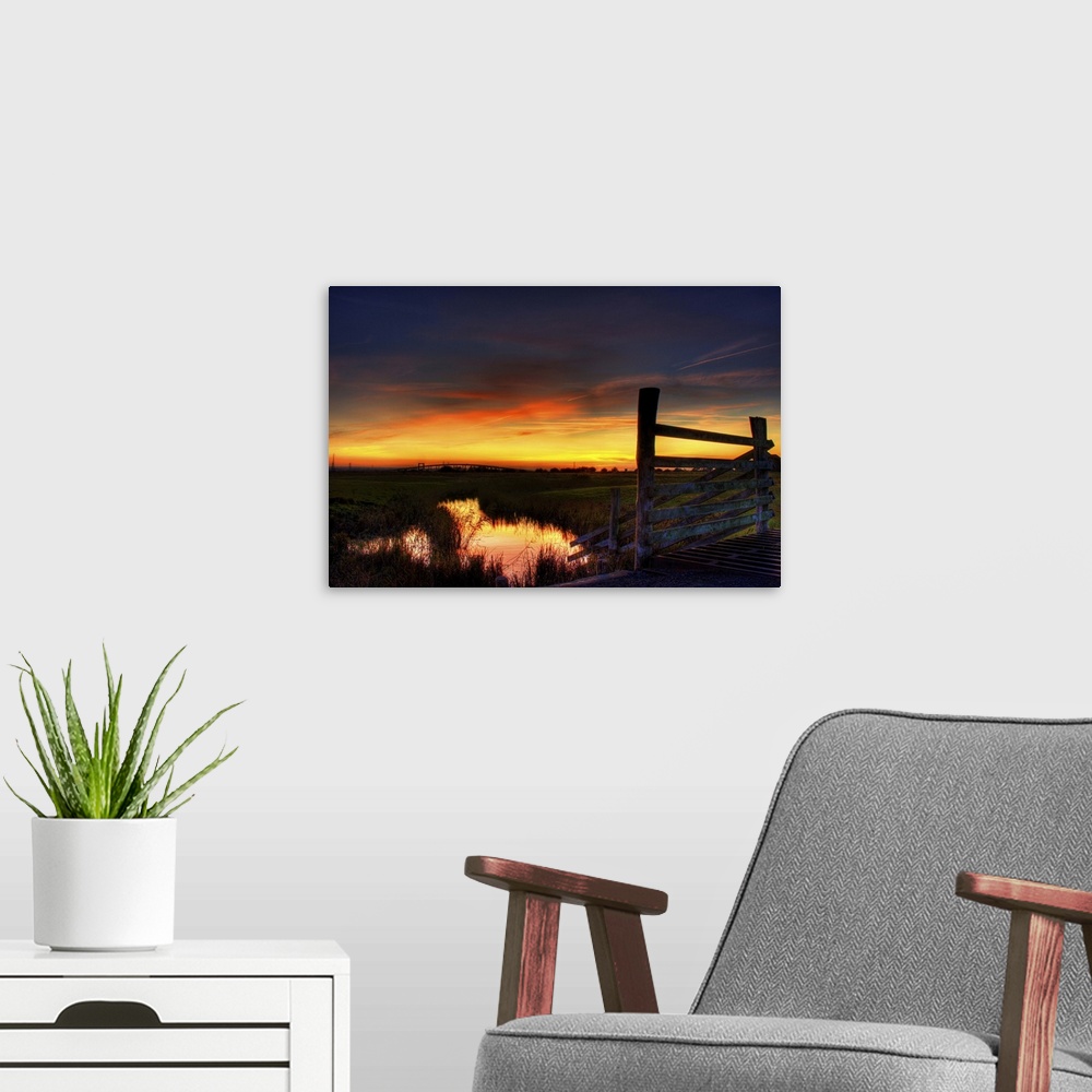 A modern room featuring Sunset over Elmley marshes, with the Swale Crossing and Kingsferry Bridge in the background and r...
