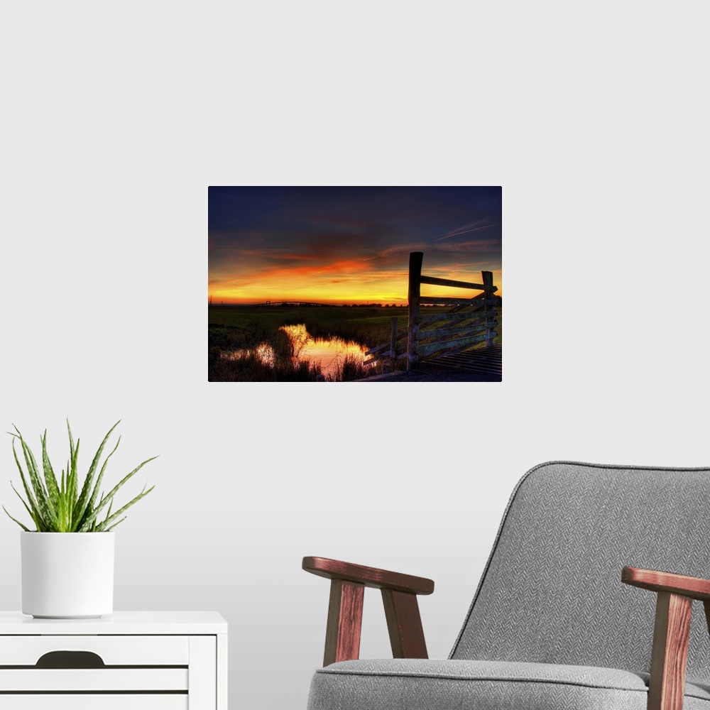 A modern room featuring Sunset over Elmley marshes, with the Swale Crossing and Kingsferry Bridge in the background and r...