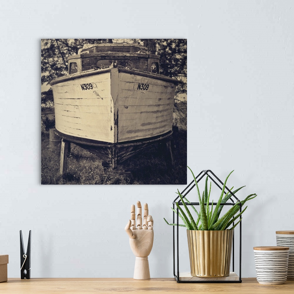 A bohemian room featuring Bow view of an old holiday cruiser moored on dry land under trees